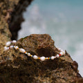 Aurora pearl bracelet on a rock by the sea